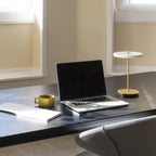 Cordless rechargeable LED table lamp, brass base, in use at home