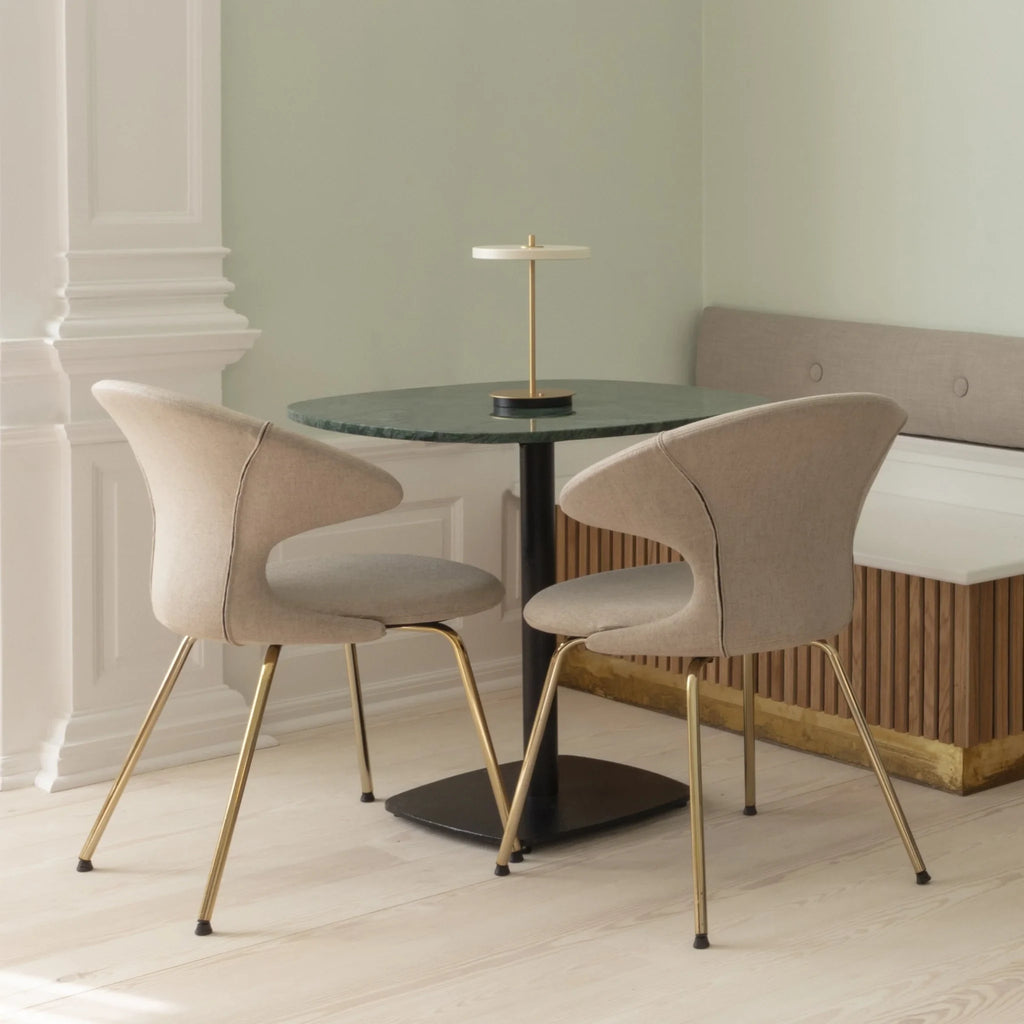 Cordless rechargeable LED table lamp, brass base, in use at home