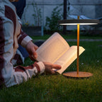 Cordless rechargeable LED table lamp, brass base, in use at home