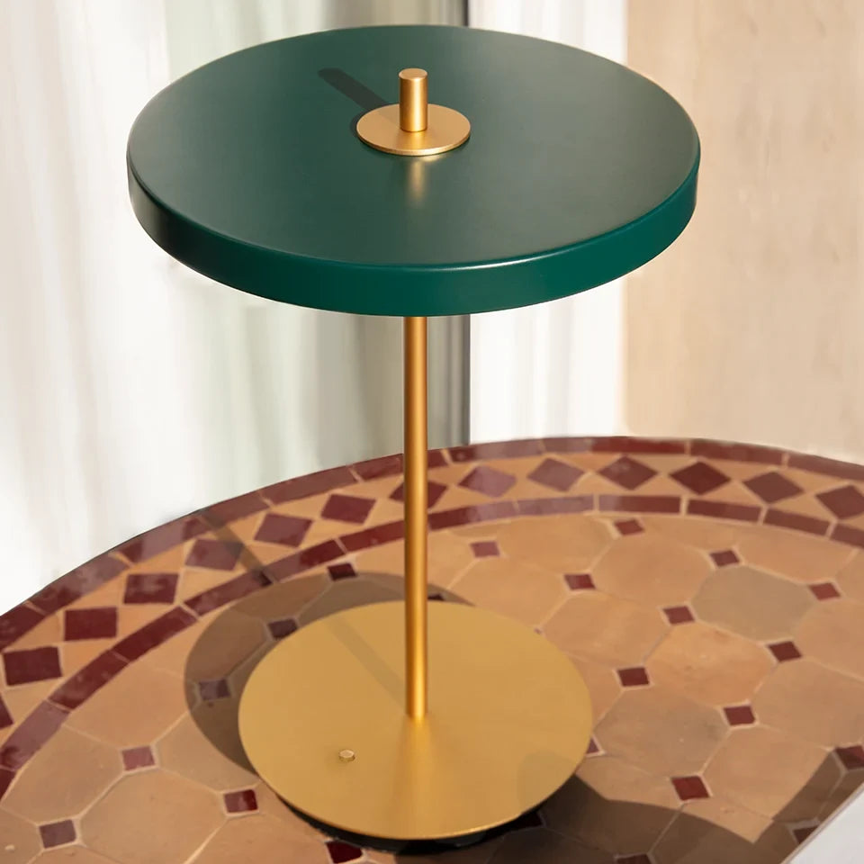 Cordless rechargeable LED table lamp, brass base, in use at home