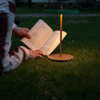 Cordless rechargeable LED table lamp, brass base, in use at home