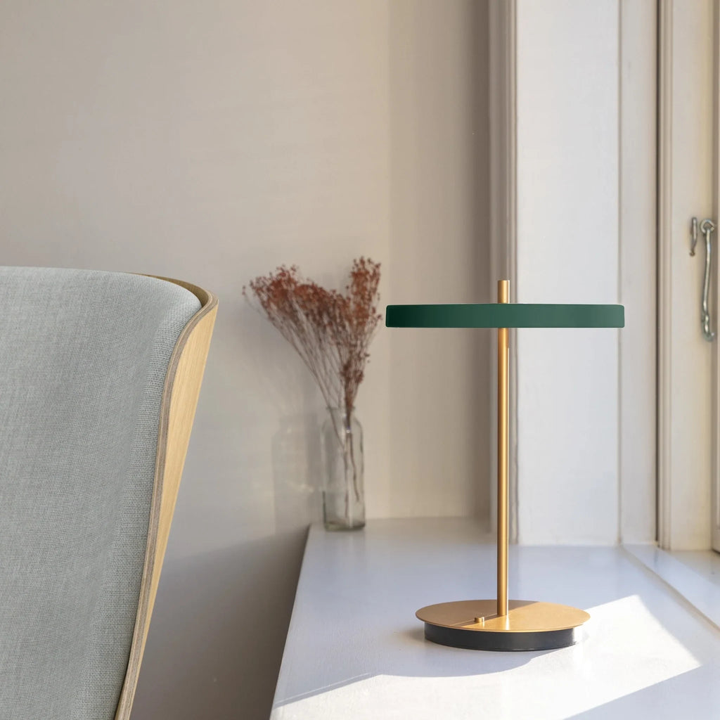 Cordless rechargeable LED table lamp, brass base, in use at home