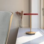 Cordless rechargeable LED table lamp, brass base, in use at home