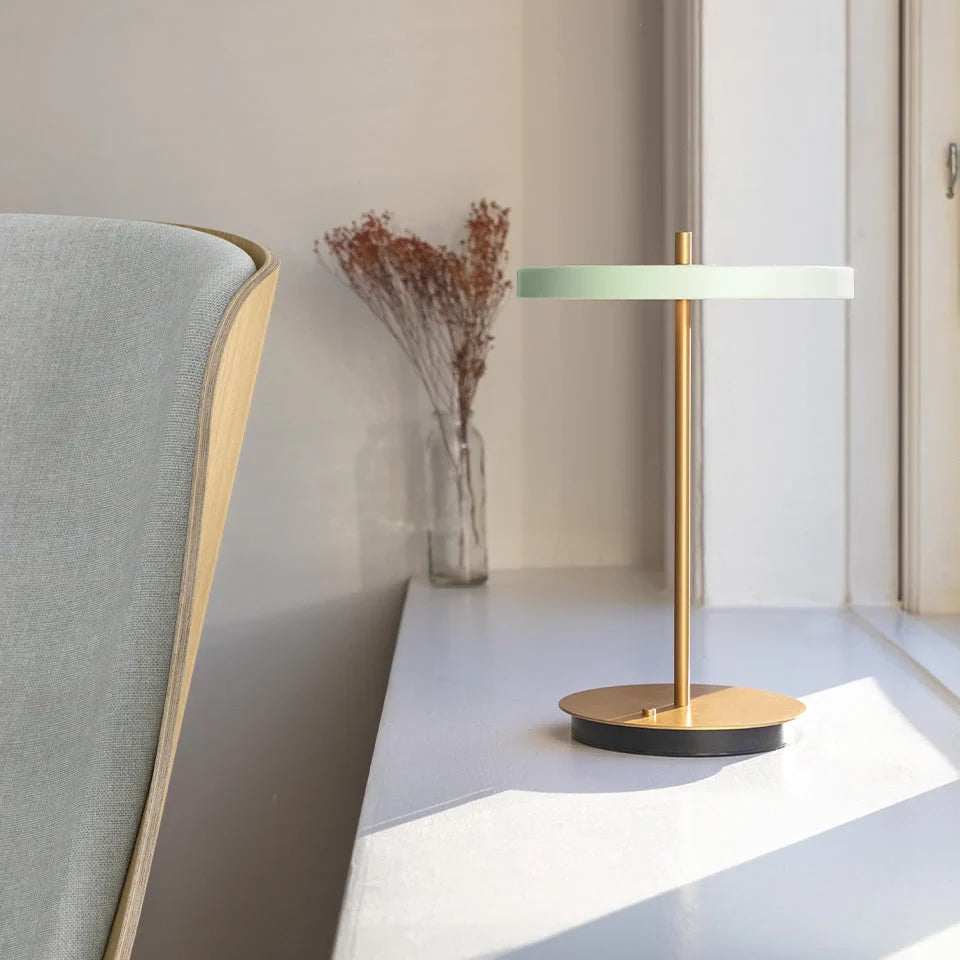 Cordless rechargeable LED table lamp, brass base, in use at home