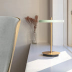 Cordless rechargeable LED table lamp, brass base, in use at home
