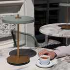 Cordless rechargeable LED table lamp, brass base, in use at home