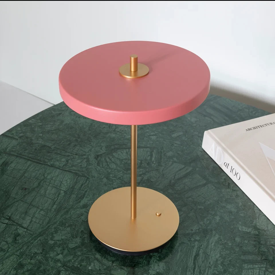 Cordless rechargeable LED table lamp, brass base, in use at home