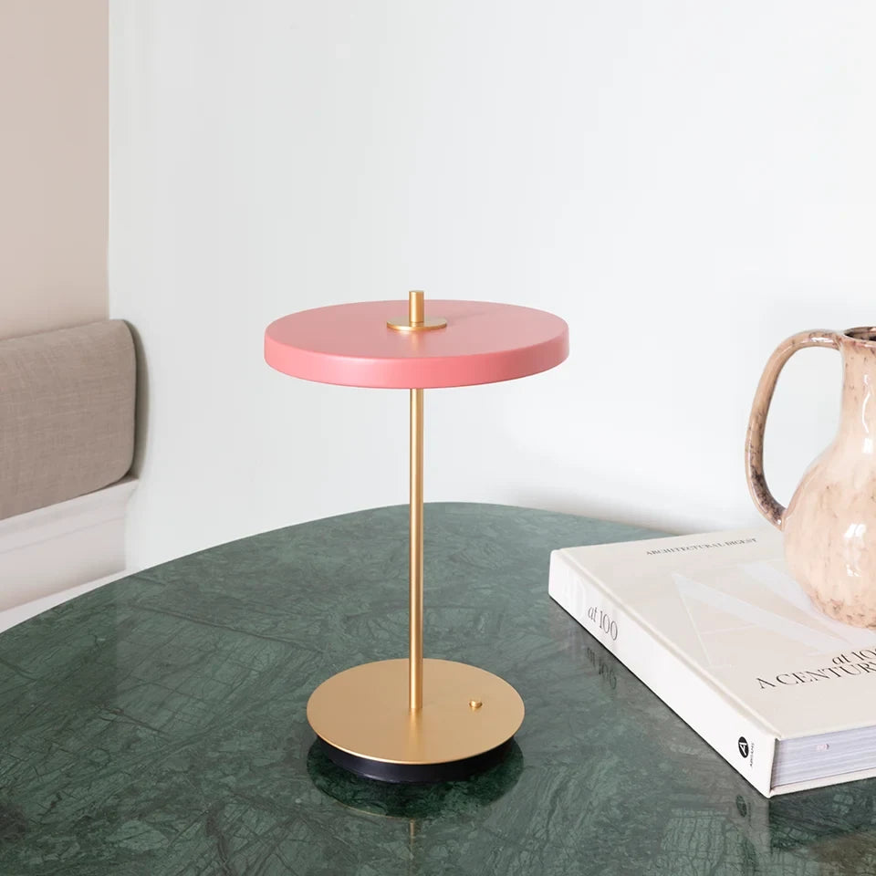 Cordless rechargeable LED table lamp, brass base, in use at home