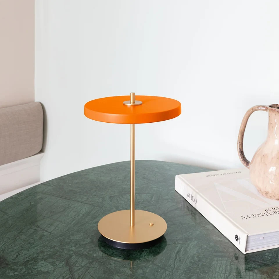 Cordless rechargeable LED table lamp, brass base, in use at home