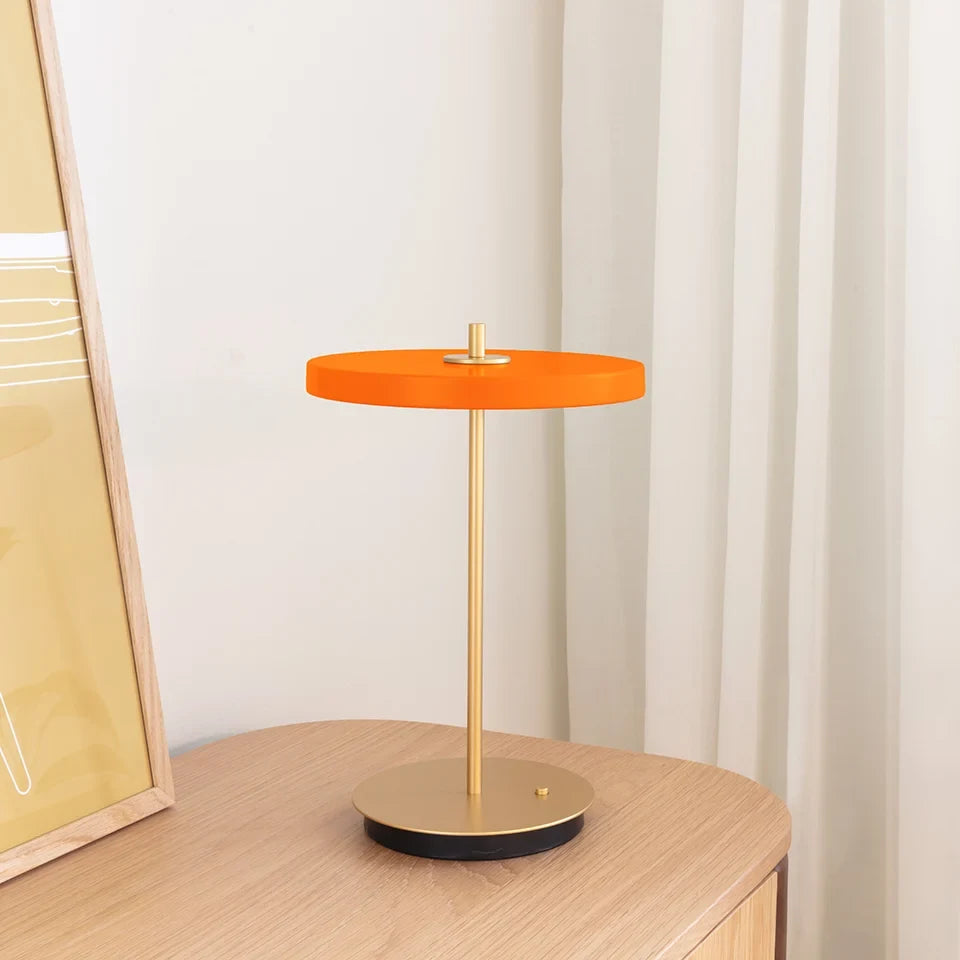 Cordless rechargeable LED table lamp, brass base, in use at home