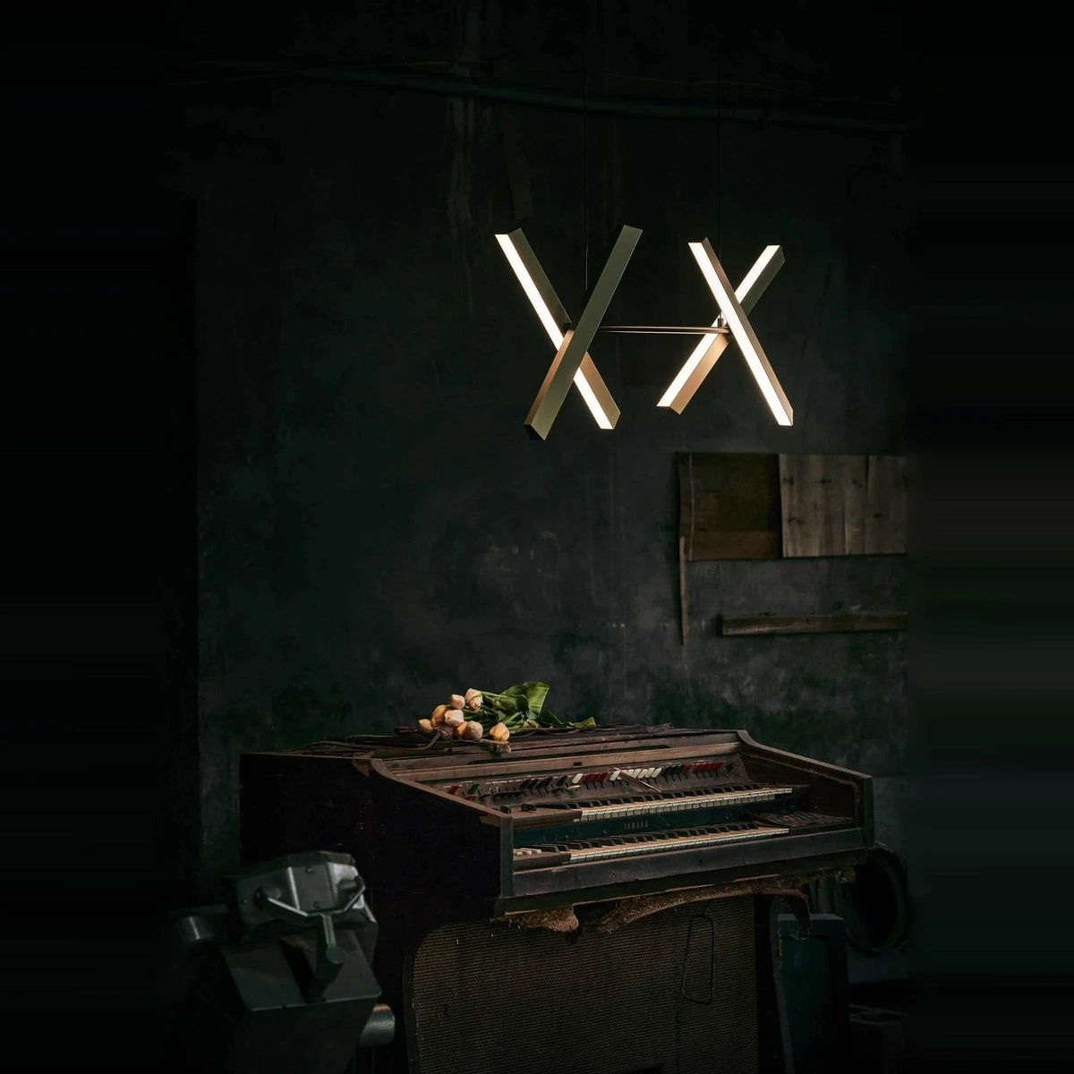 Crossed bar linear LED pendant, lit, with bars angled