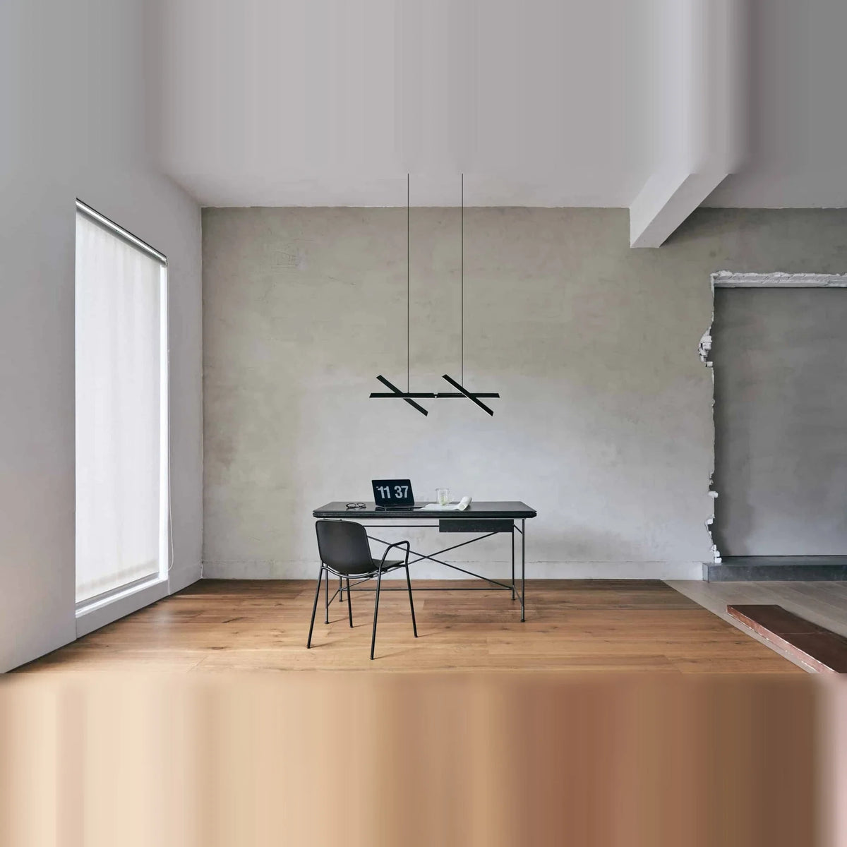 Crossed bar linear LED pendant, in an open room above a desk