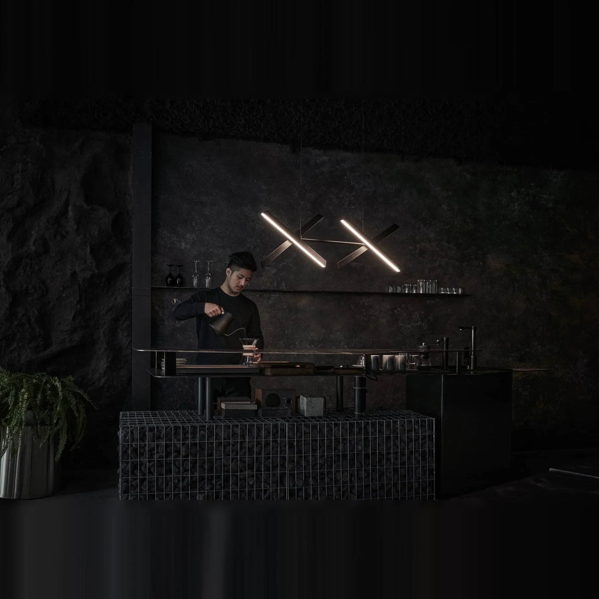 Crossed bar linear LED pendant, in a dark room