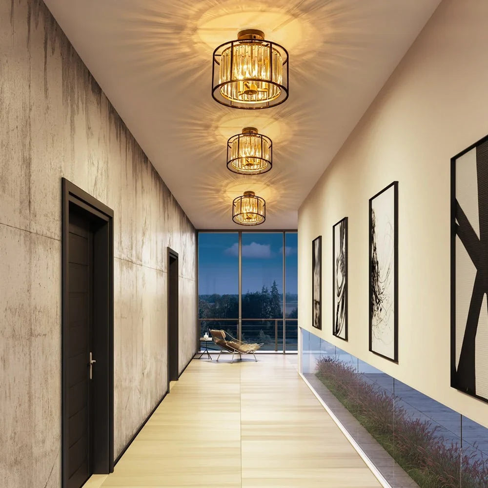 Crystal drum semi-flush ceiling light in black and brass, three in a row along a corridor