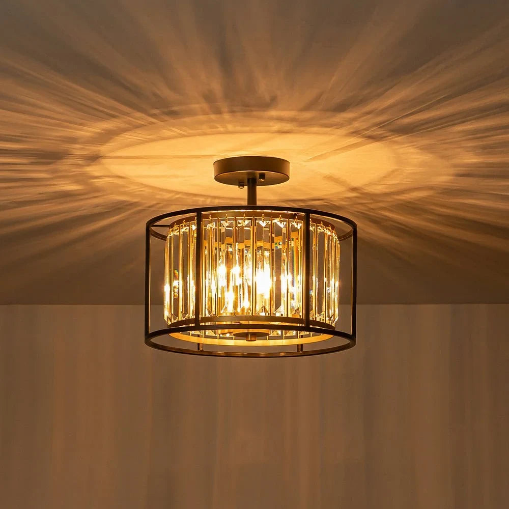 Crystal drum semi-flush ceiling light in black and brass, casting light patterns on the ceiling