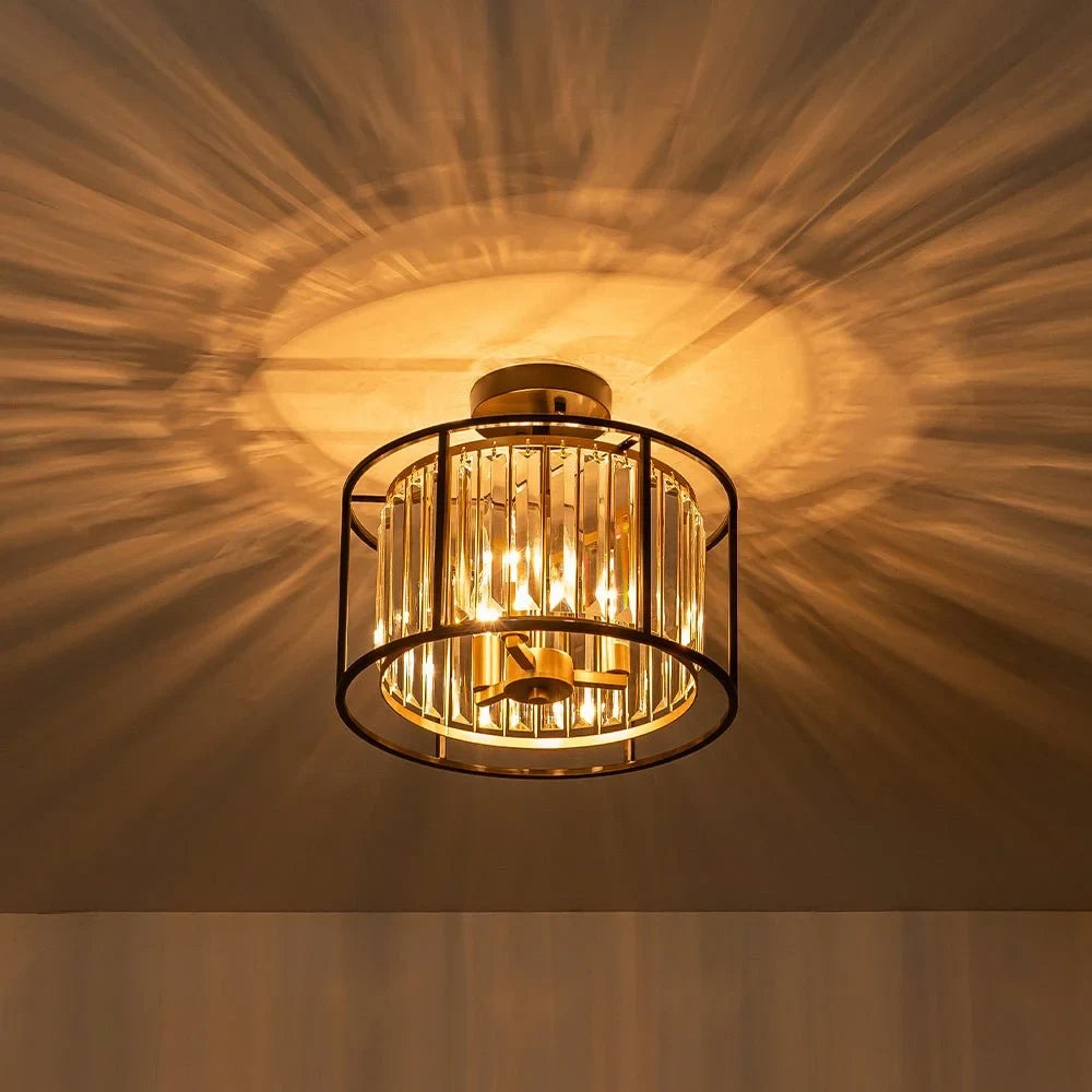 Crystal drum semi-flush ceiling light in black and brass, lit at night