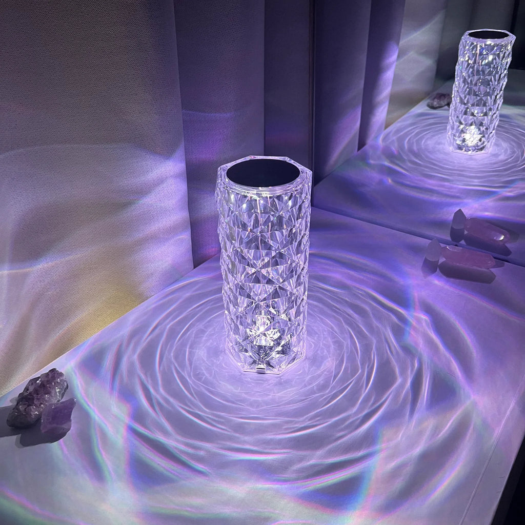 Crystal-effect cordless table lamp, lit in purple, casting patterns
