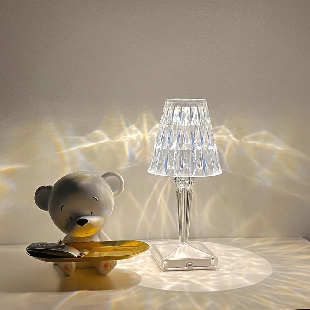Crystal-effect rechargeable table lamp, casting light patterns on a table