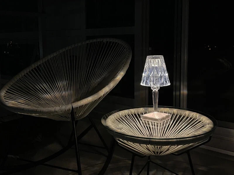 Crystal-effect rechargeable table lamp, lit on a glass table at night