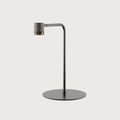 Curved-arm LED reading table lamp, in a grey metal finish, on a round base