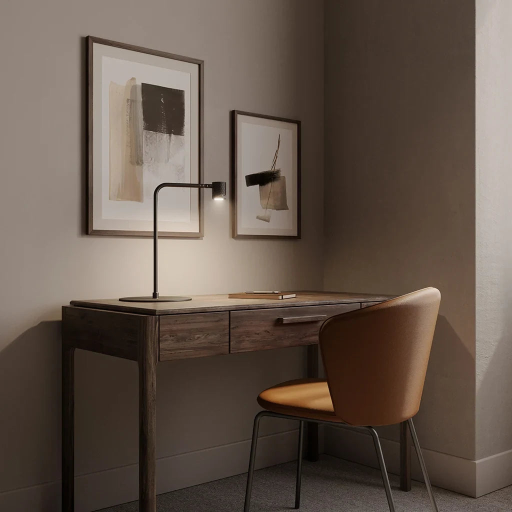 Curved-arm LED reading table lamp, on a wooden desk