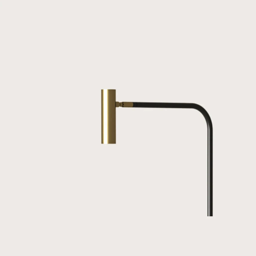 Curved-arm task floor lamp, close-up of the matte brass head