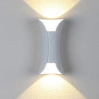 Curved up and down outdoor wall light, lit on a wall
