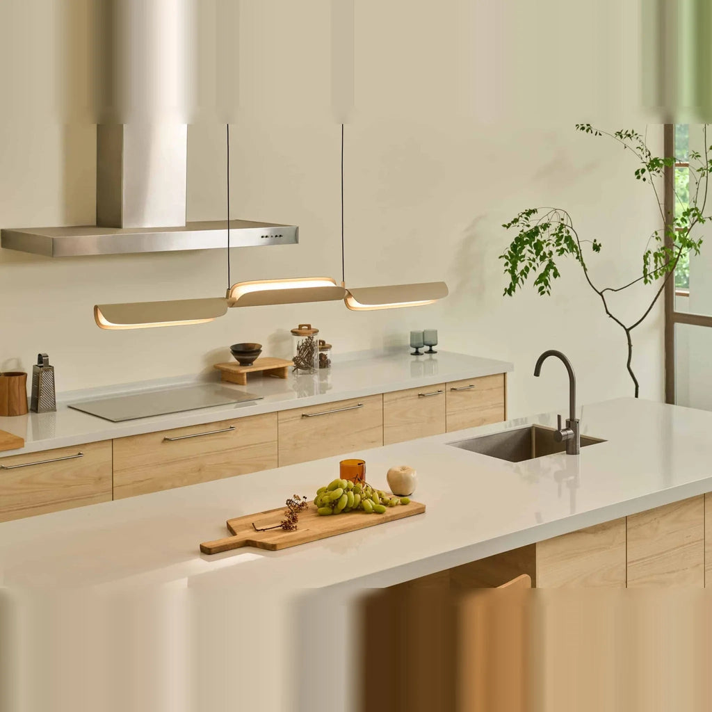 Curved shade linear LED pendant, above a kitchen worktop