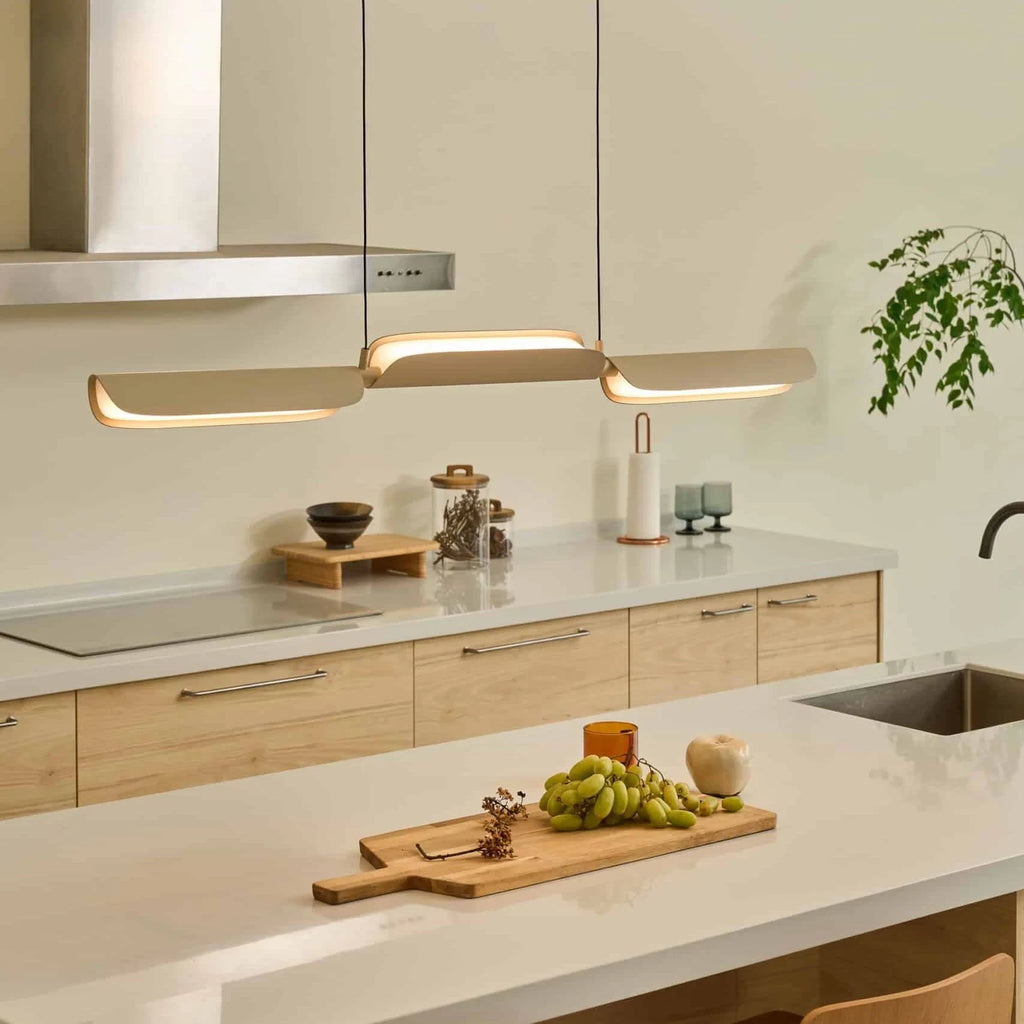 Curved shade linear LED pendant, above a kitchen island