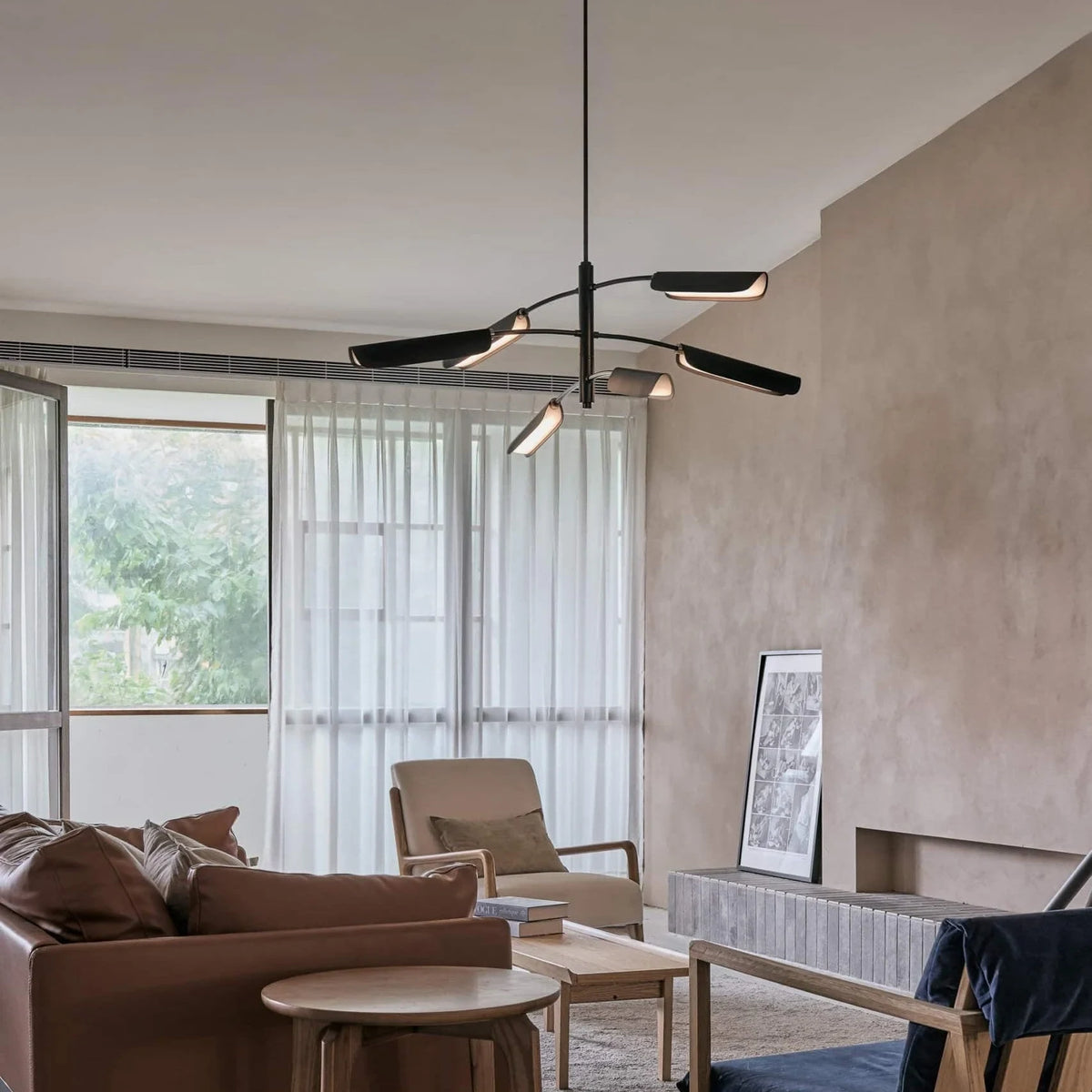 Curved shade six-arm LED pendant, in a living room