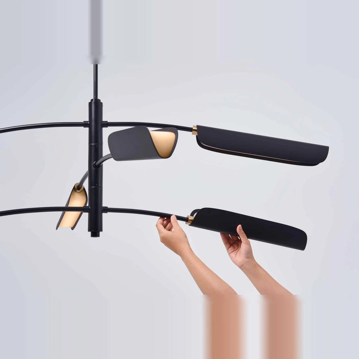 Curved shade six-arm LED pendant, shade being adjusted by hand