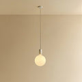 Cylinder pendant with matt white globe bulb, chalk, lit, against a plain wall
