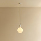 Cylinder pendant with matt white globe bulb, chalk, lit, against a plain wall