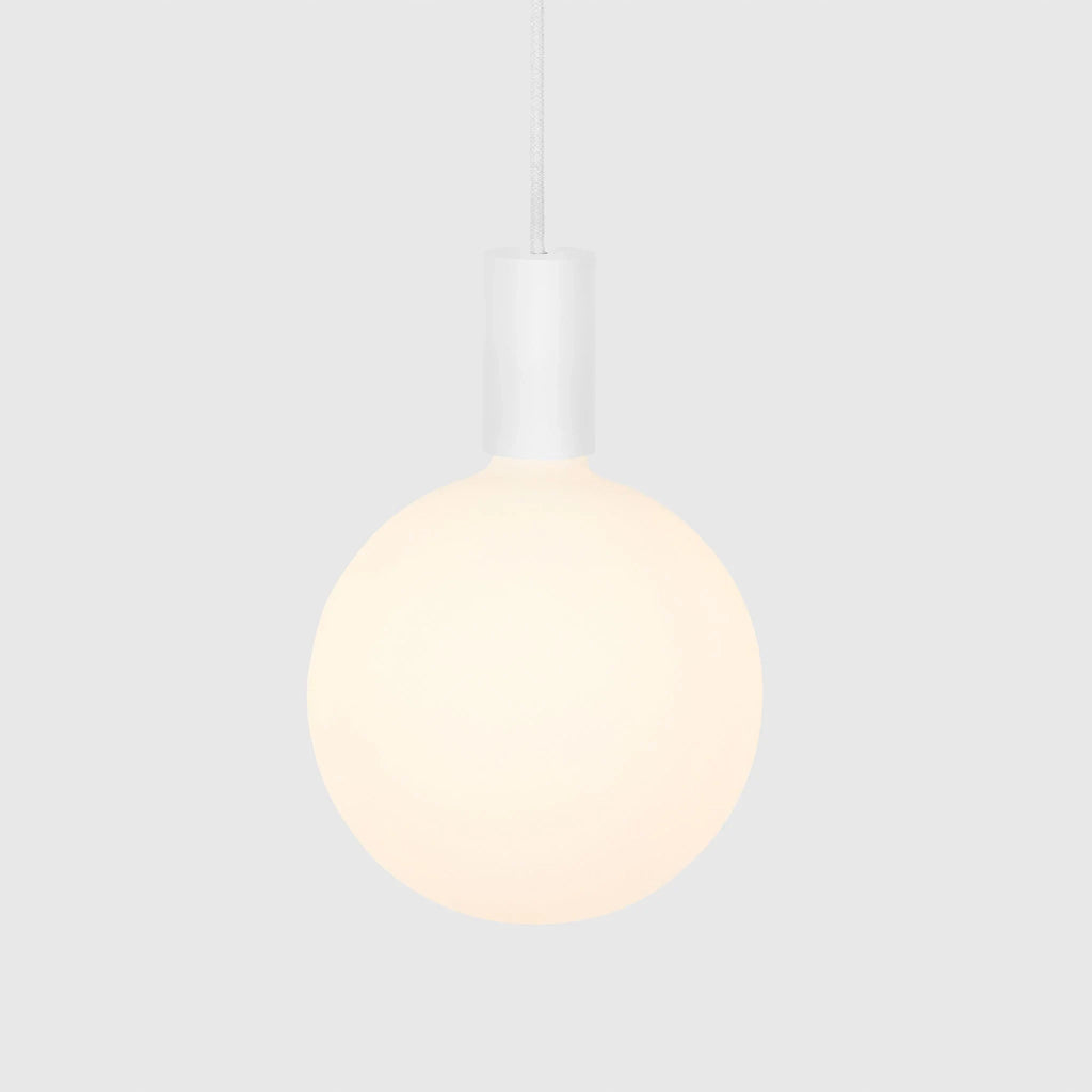 Cylinder pendant with matt white globe bulb, chalk, bulb at a warm dimmed setting