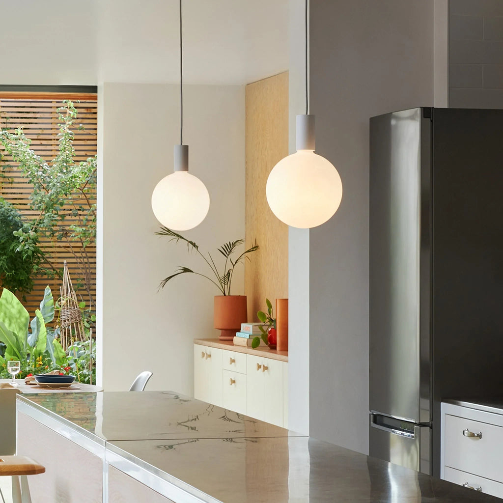 Cylinder pendant with matt white globe bulb, chalk, in a kitchen with a fridge
