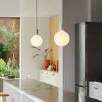 Cylinder pendant with matt white globe bulb, chalk, in a kitchen with a fridge