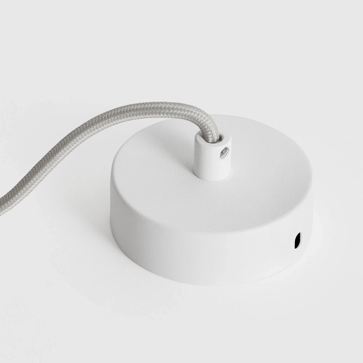 Cylinder pendant with matt white globe bulb, chalk, close-up of the canopy, on a plain background