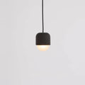 Dark concrete and glass mini pendant, lit, close-up