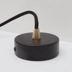 Dim-to-warm globe pendant, graphite, close-up of the round canopy