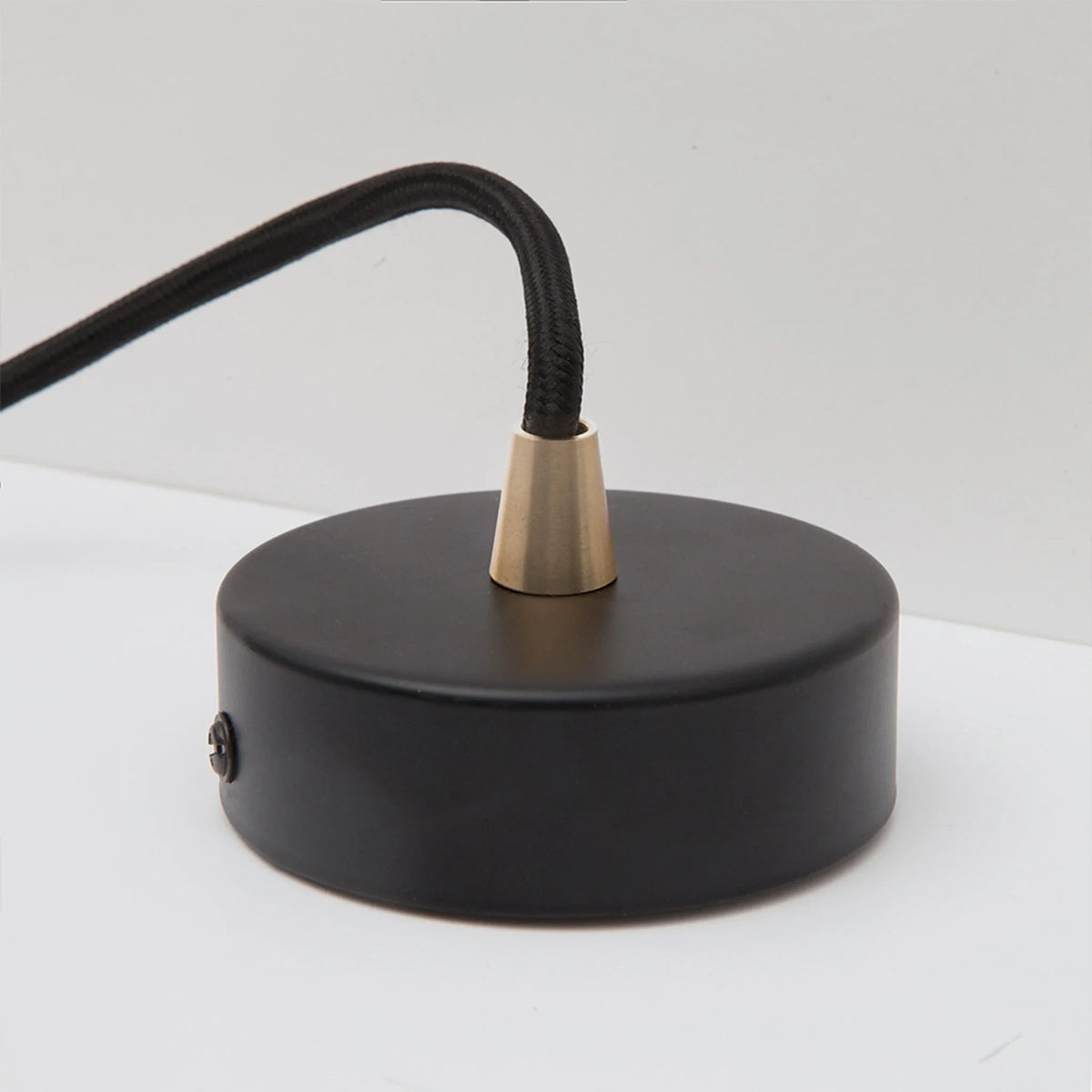 Dim-to-warm globe pendant, walnut, close-up of the round canopy