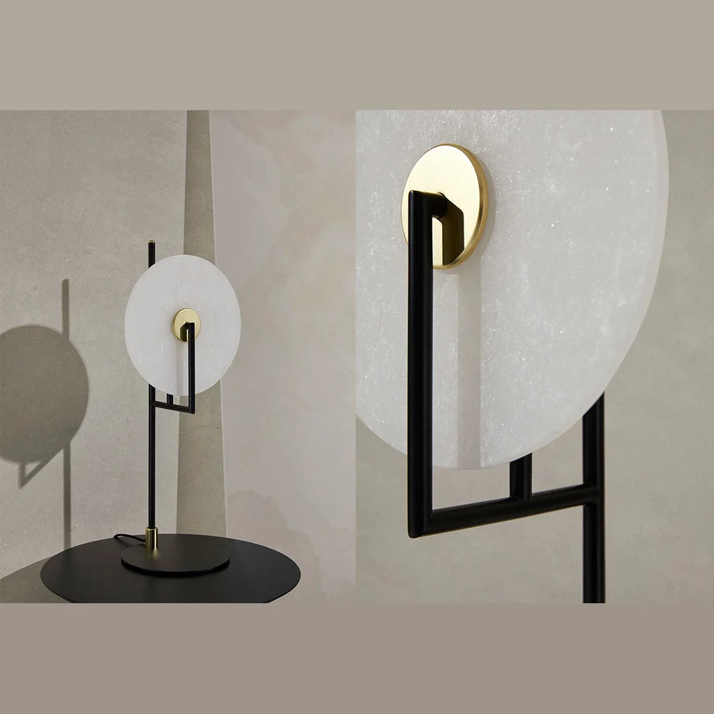 Open frame table lamp, with an alabaster disc, lit, in a room