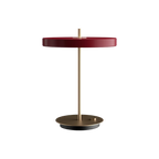 Disc-top LED table lamp with brass stem, in ruby red