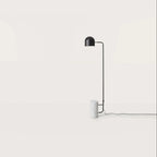 Dome shade reading floor lamp with white marble base, against a plain wall