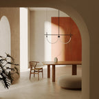 Double curved opal tube linear LED pendant, above a dining table