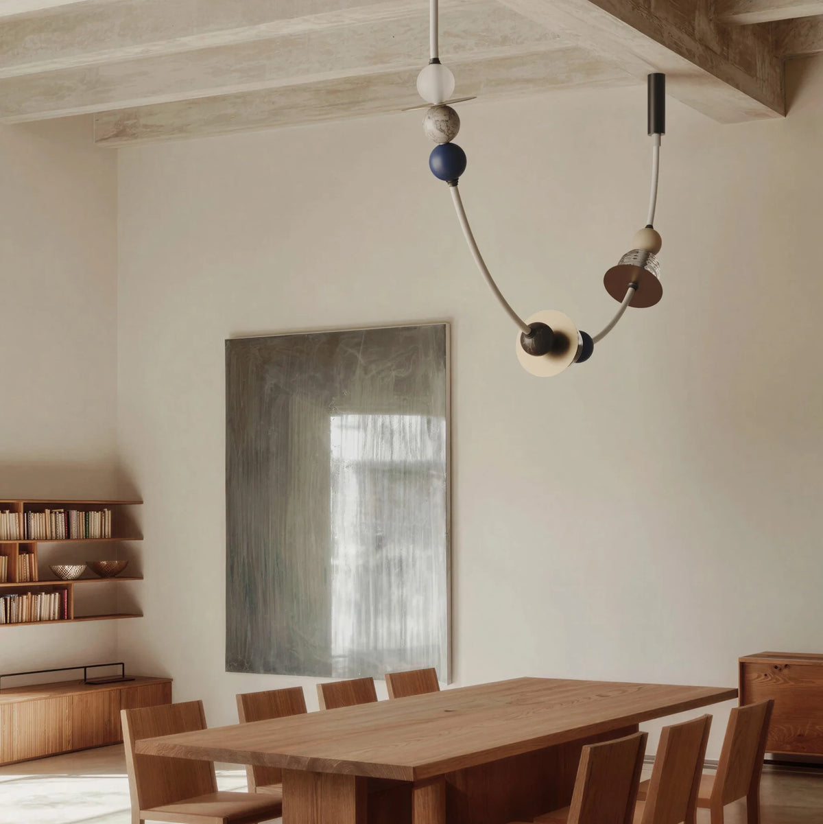 Draped opal tube LED pendant, above a long dining table