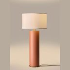 Extra-tall hand-painted ceramic cylinder table lamp, in a pink terracotta colour, lit, with a shade (sold separately)