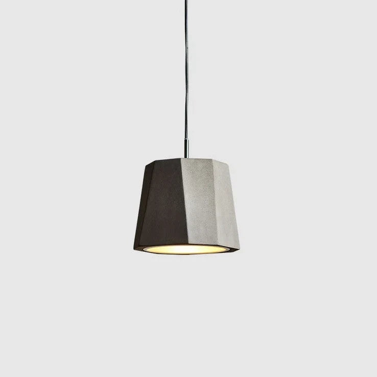 Faceted concrete pendant, on a pale background