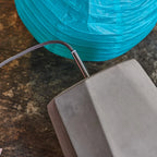 Faceted concrete pendant, detail beside a paper lantern