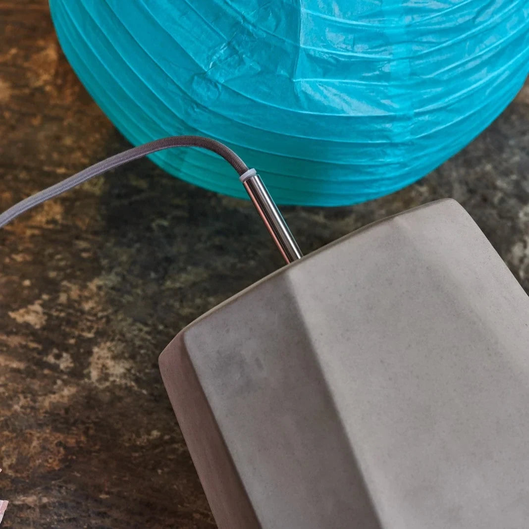 Faceted concrete pendant, detail beside a paper lantern