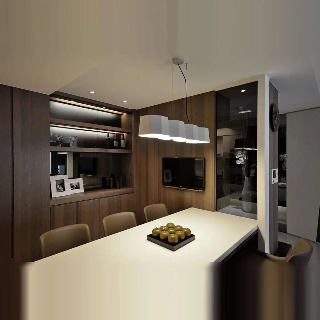 Faceted metal linear pendant, in white above a kitchen island